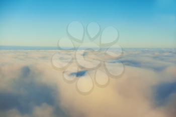 Amazing view from plane on the sky, sunset sun and clouds