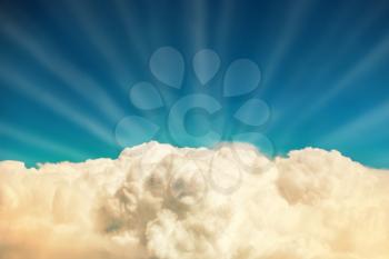 Blue clouds and sky. Natural background with sun beams