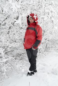 Pretty winter girl in the snow forest