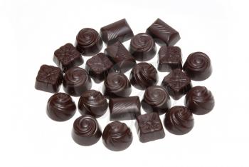 Delicious dark chocolate pralines isolated on white.