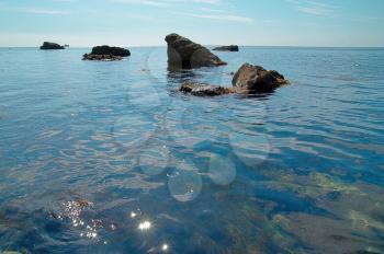 Sea landscape with rocks and water surface.