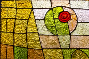 Rectangular and round stained glass window with red rose. Abstract geometric colorful background. Multicolored stained glass church window with irregular random block pattern.