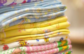 Stack of swaddling bands. Close-up of corner a laid colored laundry. Heap of folded linen of various colors. Pile of the washed and ironed linen.
