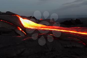 Pouring lava on the slope of the volcano. Volcanic eruption and magma