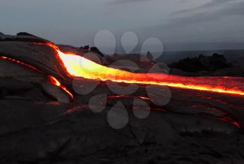 Pouring lava on the slope of the volcano. Volcanic eruption and magma