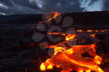 Pouring lava on the slope of the volcano. Volcanic eruption and magma