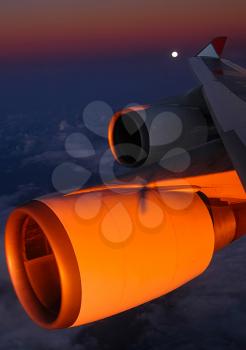 The view from the window of a passenger plane during the flight, the wing of the turbine engine of the aircraft.