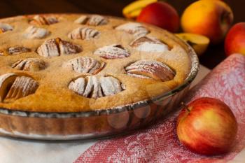 Apple pie and apples on dark wooden background, selective focus, close up