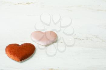 Red and pink silk hearts on a white wooden background, Valentines Day background, wedding day background