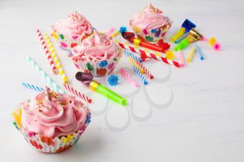 Pink cupcakes and candles birthday background . Birthday cupcakes. Gourmet cupcakes. Sweet dessert. Sweet pastry. Birthday invitation. Birthday mockup. Styled desktop. Birthday background.