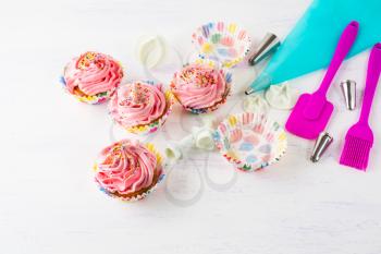 Pink homemade cupcakes  and cookware. Birthday cupcakes. Homemade cupcake. Sweet dessert. Sweet pastry.  Gourmet cupcakes. Sweet cupcake. 