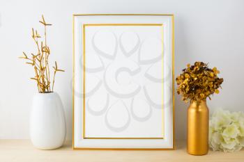 White frame mockup with white and golden vases. Portrait or poster white frame mockup. Empty white frame mockup for design presentation.