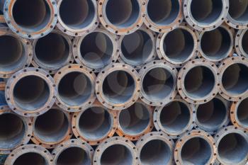 Stacked steel pipe bundle in industrial stockyard texture background