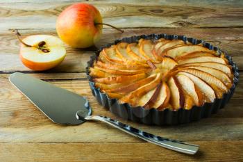 Traditional apple pie, fruit dessert, tart with fresh apples on wooden rustic table, selective focus