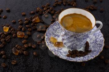 Coffee grains and china cup of coffee. Coffee cup. Strong coffee. Coffee mug. Morning coffee. Cup of coffee. Coffee break.