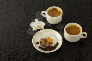 Coffee mugs and coffee beans on the black background. Morning coffee. Coffee cup. Coffee break. Cup of coffee. 