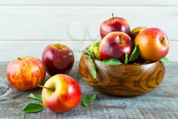 Fresh apples in the wooden bowl. Ripe fruits as healthy eating or vegetarian food concept. 