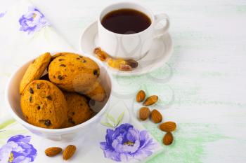 Sweet cookies,  tea cup and almond. Sweet dessert. Homemade biscuit. Breakfast cookies. Tea cup. Tea time. Homemade cookies.