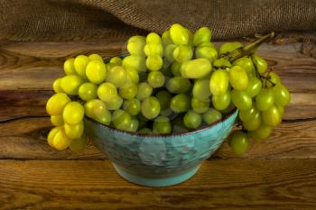 Bunch of white grapes on a dark wooden background. Cluster of grapes. Bunch of grapes. Custer grapes. Bunch grapes. Grapes. Grape