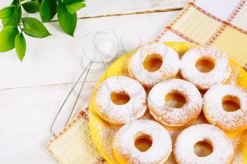 Donuts powdered by caster sugar on checkered napkin. Hanukkah sweet donuts. Sweet dessert pastry doughnuts.   