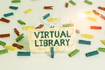 Handwriting text writing Virtual Library. Conceptual photo collection of resources available on computer systems Colored clothespin papers empty reminder white floor background office