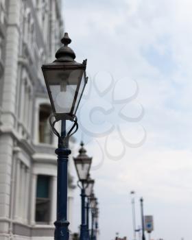 Light post on the road. Street light post. Street lamp on the road. Cast iron street lamp. Designer lamp post. Lamps on the top of lamppost. Street road light