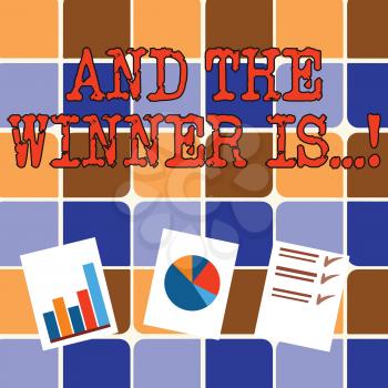 Writing note showing And The Winner Is. Business concept for announcing who got first place at competition or exam Presentation of Bar, Data and Pie Chart Graph on White Paper