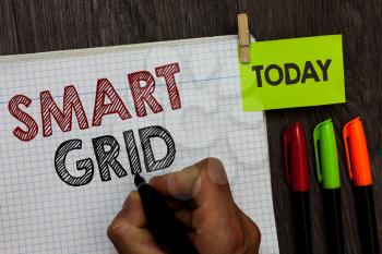Conceptual hand writing showing Smart Grid. Business photo text includes of operational and energy measures including meters Man holding marker notebook clothespin markers wooden table