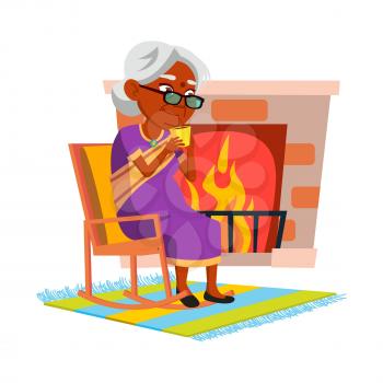 Elderly Woman Drinking Tea In Living Room Vector. Indian Old Lady Sitting In Chair Near Fireplace And Drink Hot Tea. Character Mature Person Enjoy Delicious Beverage At Home Flat Cartoon Illustration