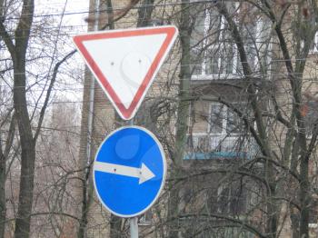 Road signs indicating the direction of movement of cars and pedestrians
