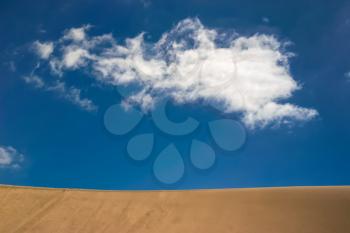 A cloud passing over the sand dunes in Gran Canaria