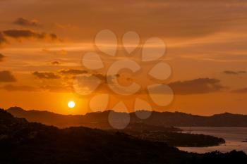 Sun setting beyond Palau in Sardinia