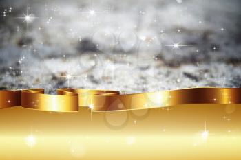 Defocused grey background with bokeh and golden ribbon.