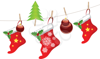 Red Christmas stockings hanging on a rope with wood pegs.