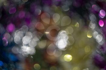 Defocused decorative Christmas tinsel as background with bokeh effect.