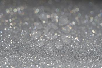 Decorative grey glitter texture macro, defocused background, bokeh.