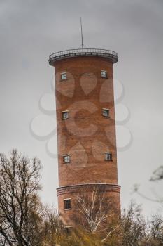 Vintage style red brick water tower of an old factory.