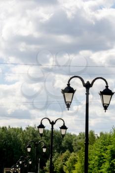 Vintage street lamp in the city park at sunny day.