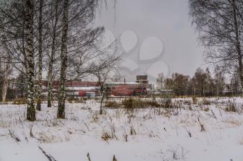 Vintage style red brick old factory, winter time landscape.