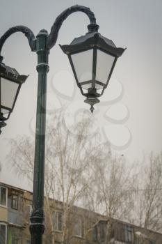 Vintage street lamp in the city park at sunny day.