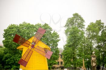 Vintage decorative yellow windmill, close up background.