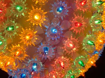 Shining ball with multicolor small electric bulbs, Christmas lights.