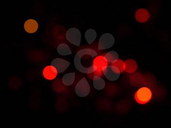 Abstract blurred background with red light bokeh effect.