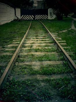 Old forgotten railroad in the dark, vintage background.