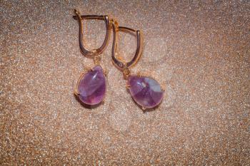 Fashion rose gold earrings made of natural purple amethyst gemstone.