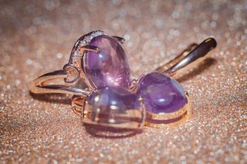 Fashion rose gold earrings and ring made of natural purple amethyst gemstone.