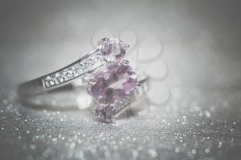 Fashion silver ring decorated with natural amethyst gemstone filtered.