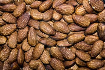 Close up background with almond nuts, macro photo.