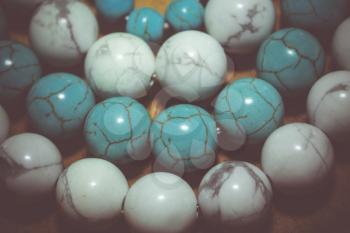 Beads with natural stone blue and white turquoise close up filtered colors.