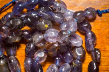 Purple irregular iolite, natural stone beads background.